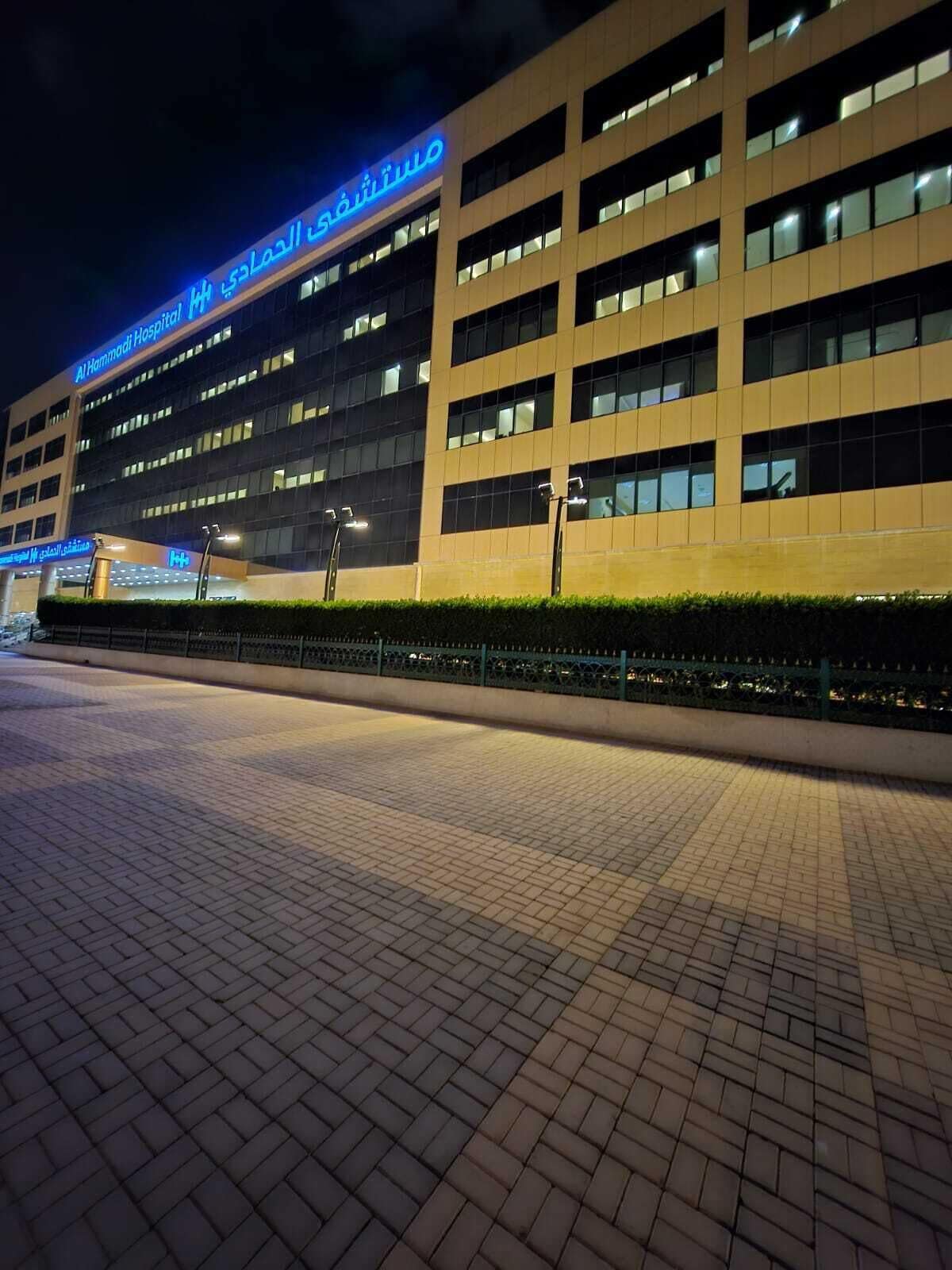 A modern building with a sign reading 'Al Hamadi Hospital.'