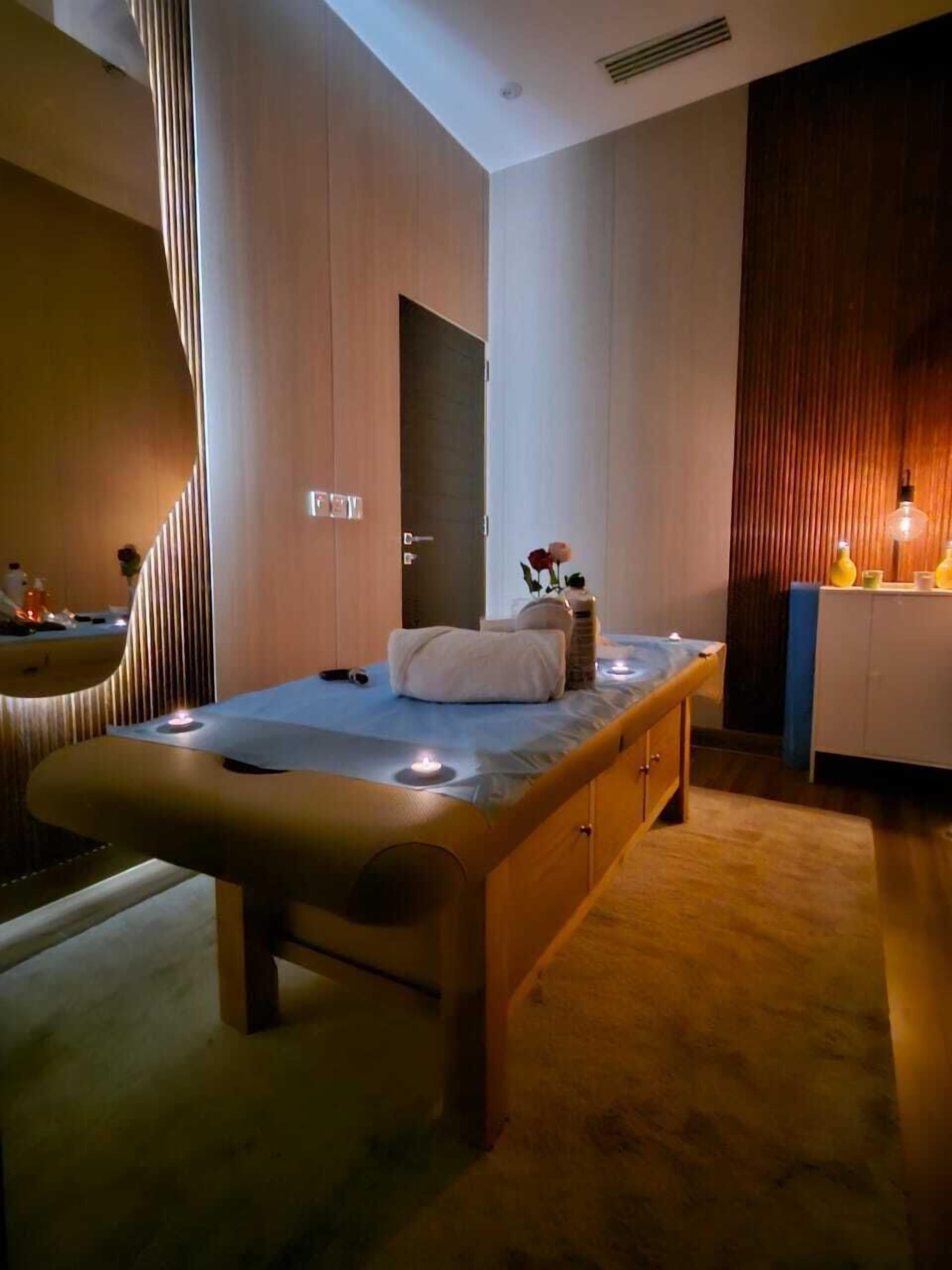 A modern bedroom with a wooden bed, a small bedside table, and a nightstand.