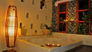 A spa area with a bathtub, potted plants, and a decorative lamp. - Oopkaew Resort (Pua)