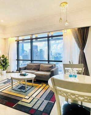 Deluxe Apartment with City View | Living area | 32-inch LED TV with cable channels, TV, DVD player - KL Service Apartment at Times Square (Kuala Lumpur)