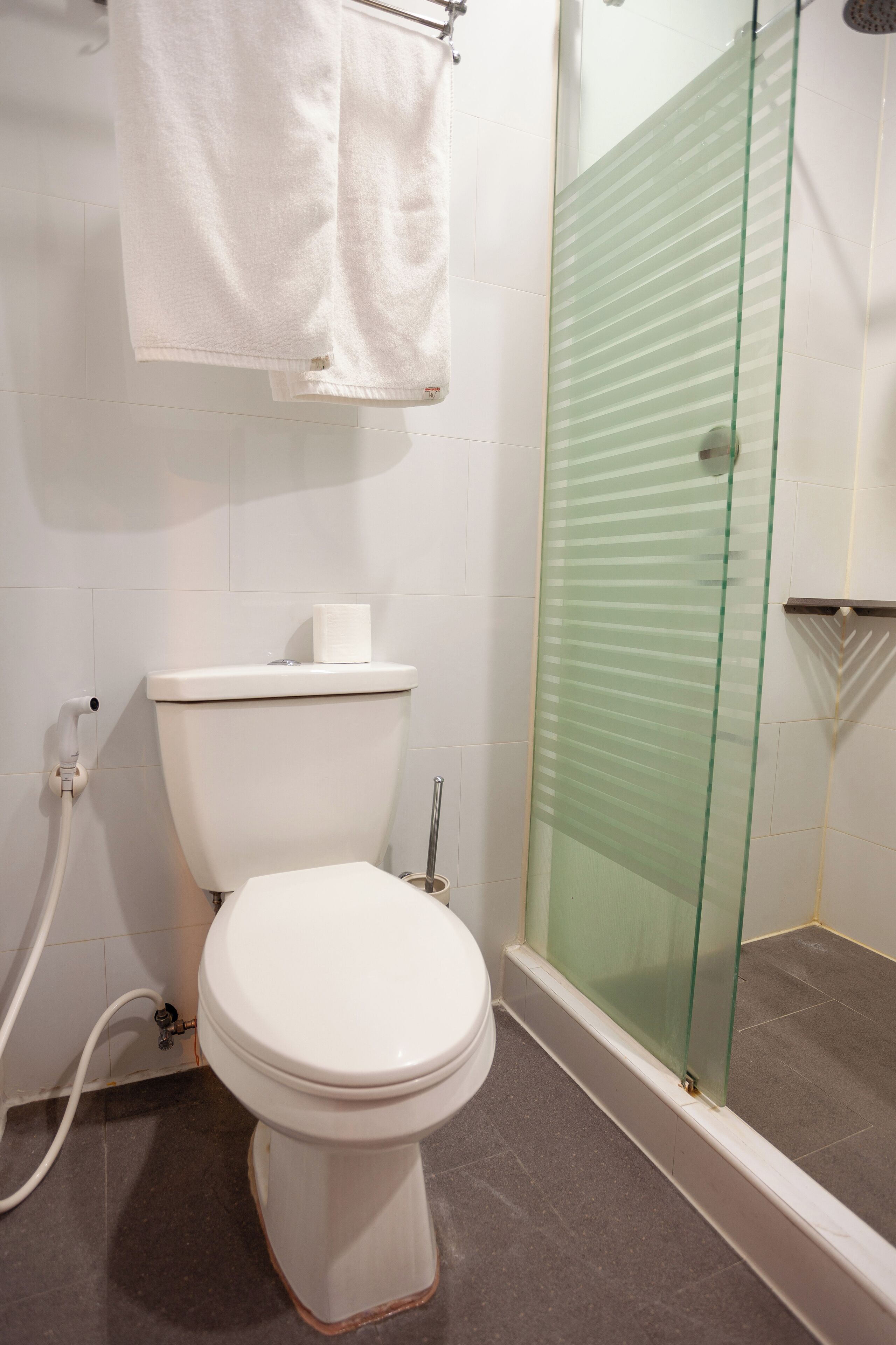 economy deluxe room | bathroom | hair dryer, bidet, towels