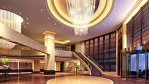 A spacious lobby with a central circular floor, a grand chandelier, and a staircase leading to an upper level. - Winnerway Hotel (Dongguan)