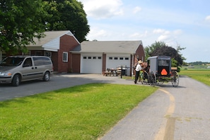 A building with a garage, a picnic table, and a horse-drawn carriage. - Sit on the porch and watch all the  buggies pass by


 















 (Gordonville)