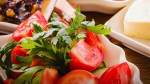 A variety of dishes including a salad with tomatoes and parsley, a bowl of soup, and a plate of cheese. - Charming Cave Hotel (Nevsehir)