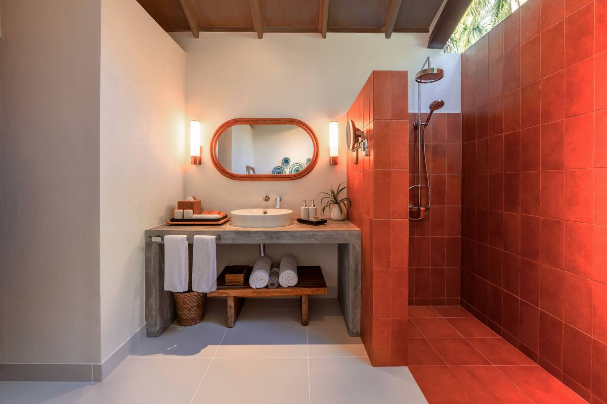 deluxe sunset villa with pool | bathroom | rainfall showerhead, eco-friendly toiletries, hair dryer, bathrobes