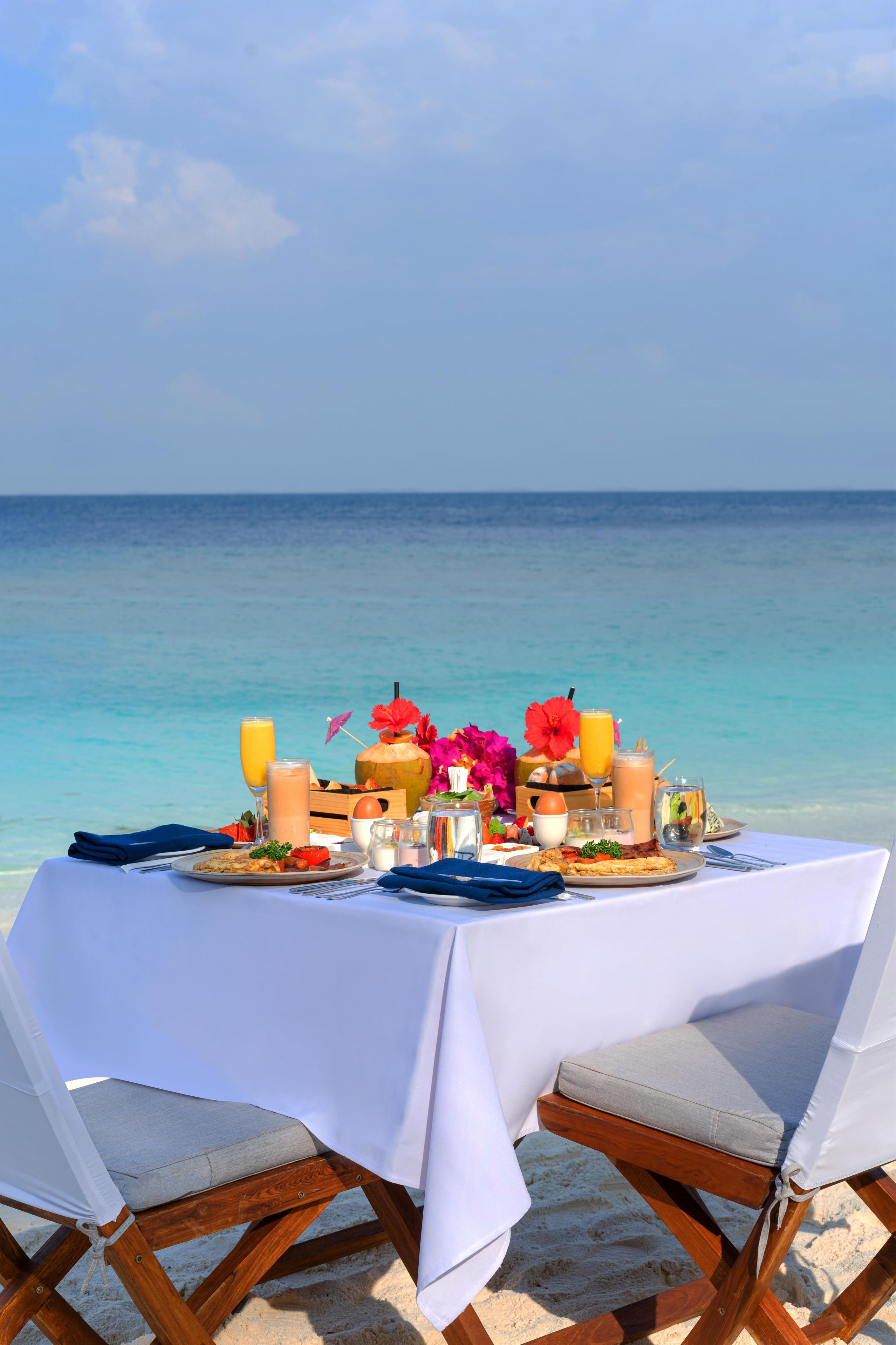 A table set for two with a view of the ocean.