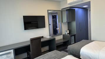 Family Room, 1 Bedroom, City View | Minibar, in-room safe, desk, soundproofing