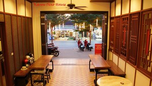 A traditional Japanese-style room with tatami flooring, low tables, and sliding doors. - Karon Sino House (Karon)