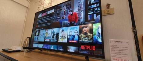 A television displaying various Netflix shows and movies.