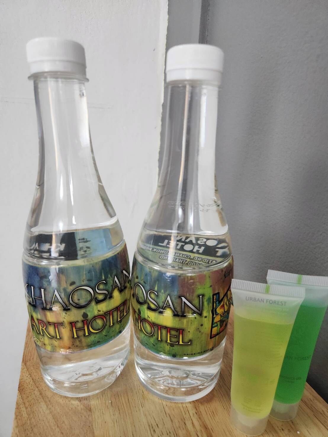 Two bottles labeled "CHAOSAN ART HOTEL" and a tube of "URBAN FOREST" product.