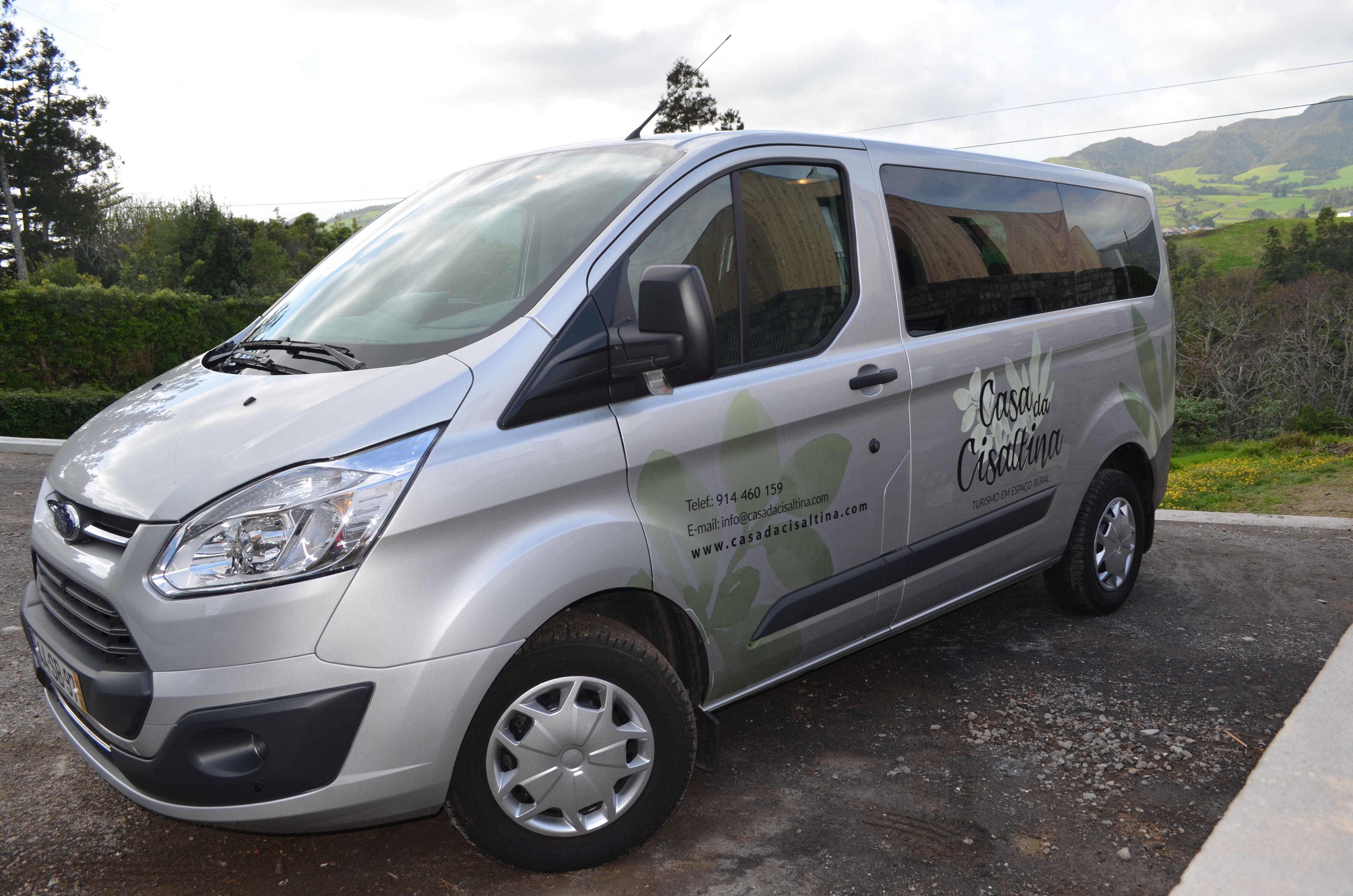 A silver van with "Casa da Casalina" branding and contact information.