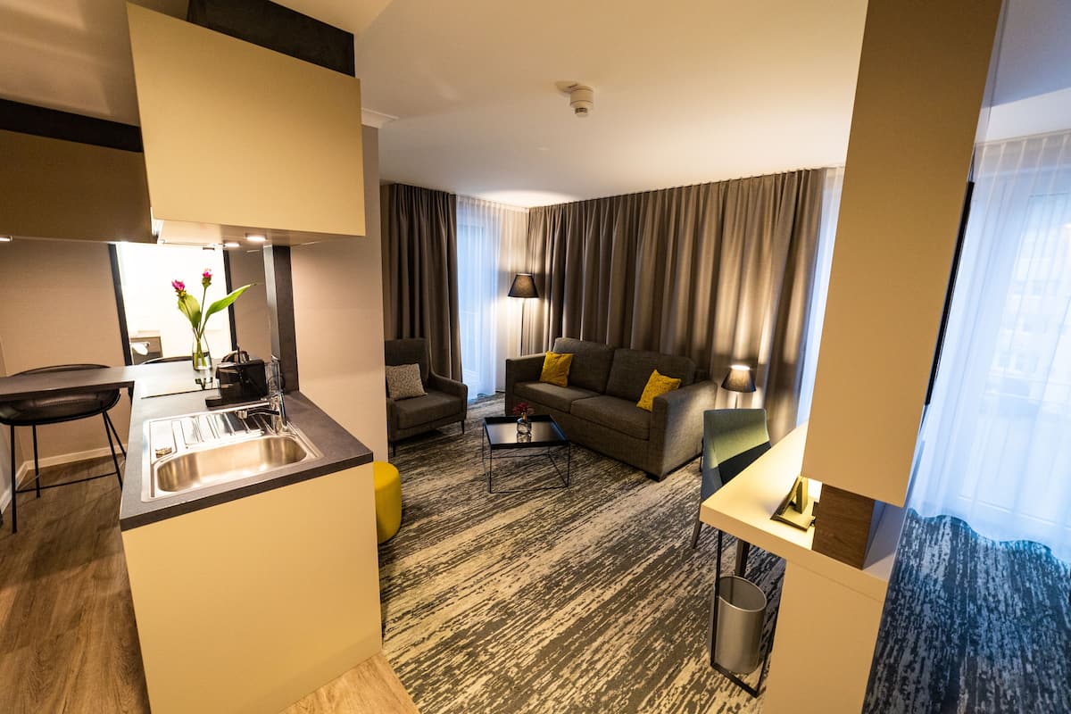 deluxe studio, 1 bedroom, non smoking, annex building (boardinghouse) | living area | 49-inch flat-screen tv with cable channels, tv, tablet