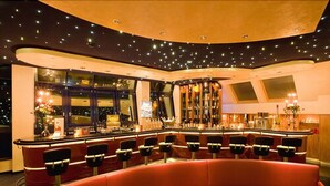 A bar area with a curved seating arrangement and a bar counter. - Kranz Parkhotel (Siegburg)