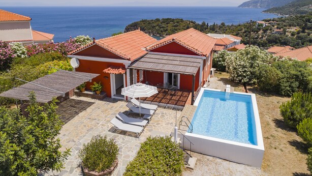 A villa with a swimming pool, outdoor seating, and a view of the sea. - Mouzakis Villas (Samos)