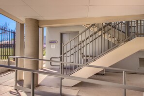 Stairs lead to an upper level, with an elevator available for access.