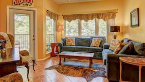 A cozy living room with a sofa set, a coffee table, and a rug.