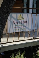 A sign for "Alle Terme Bed & Breakfast" with contact information and website.