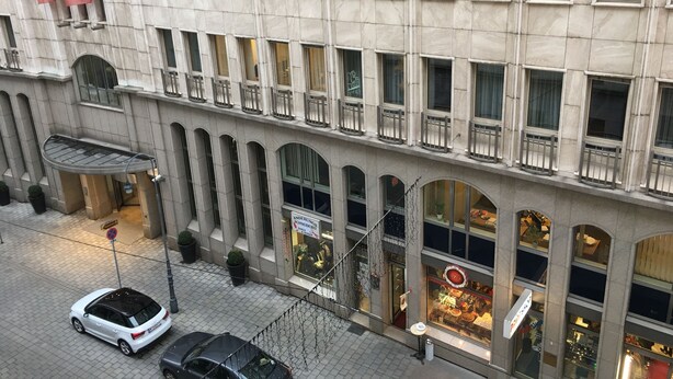A multi-story building with a classical architectural style, featuring a series of balconies and large windows.
