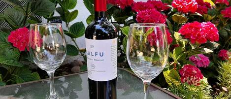 Una ampolla de vi Calfu Cabernet Sauvignon sobre una taula amb dos vasos de vi buits.