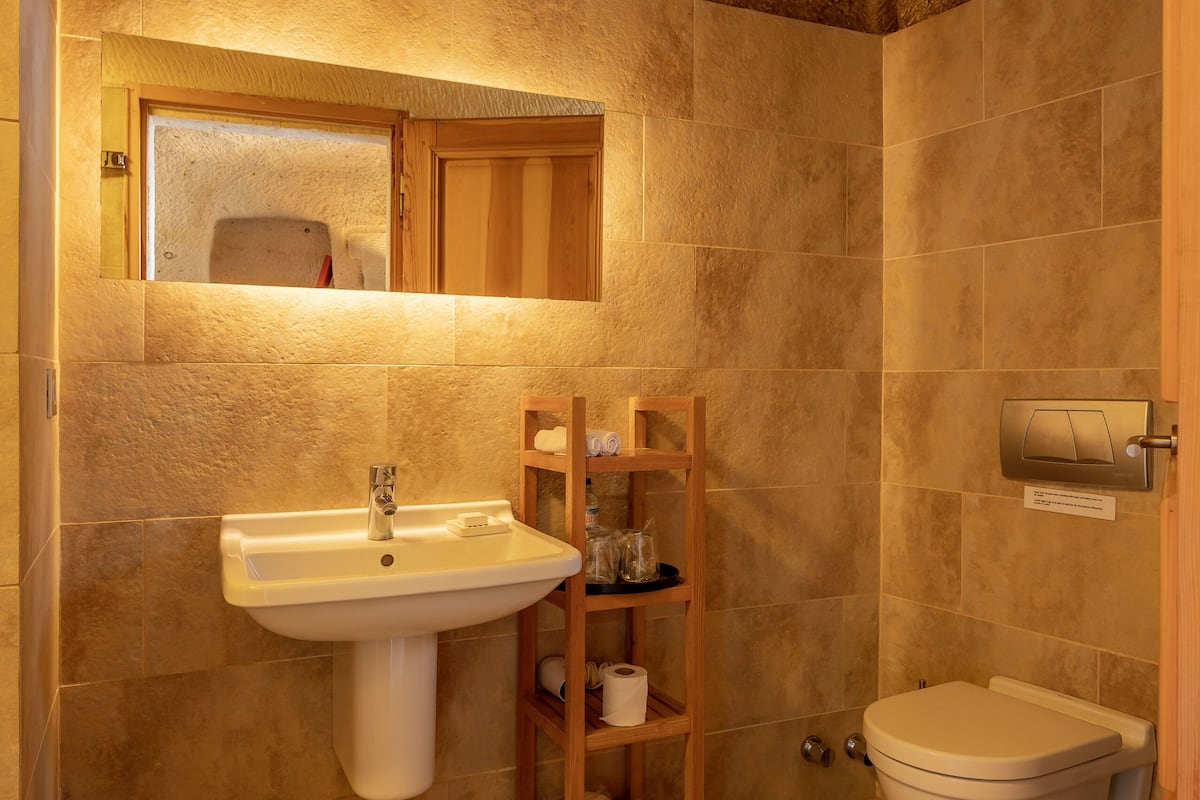 deluxe double room (cave) | bathroom | shower, free toiletries, hair dryer, slippers