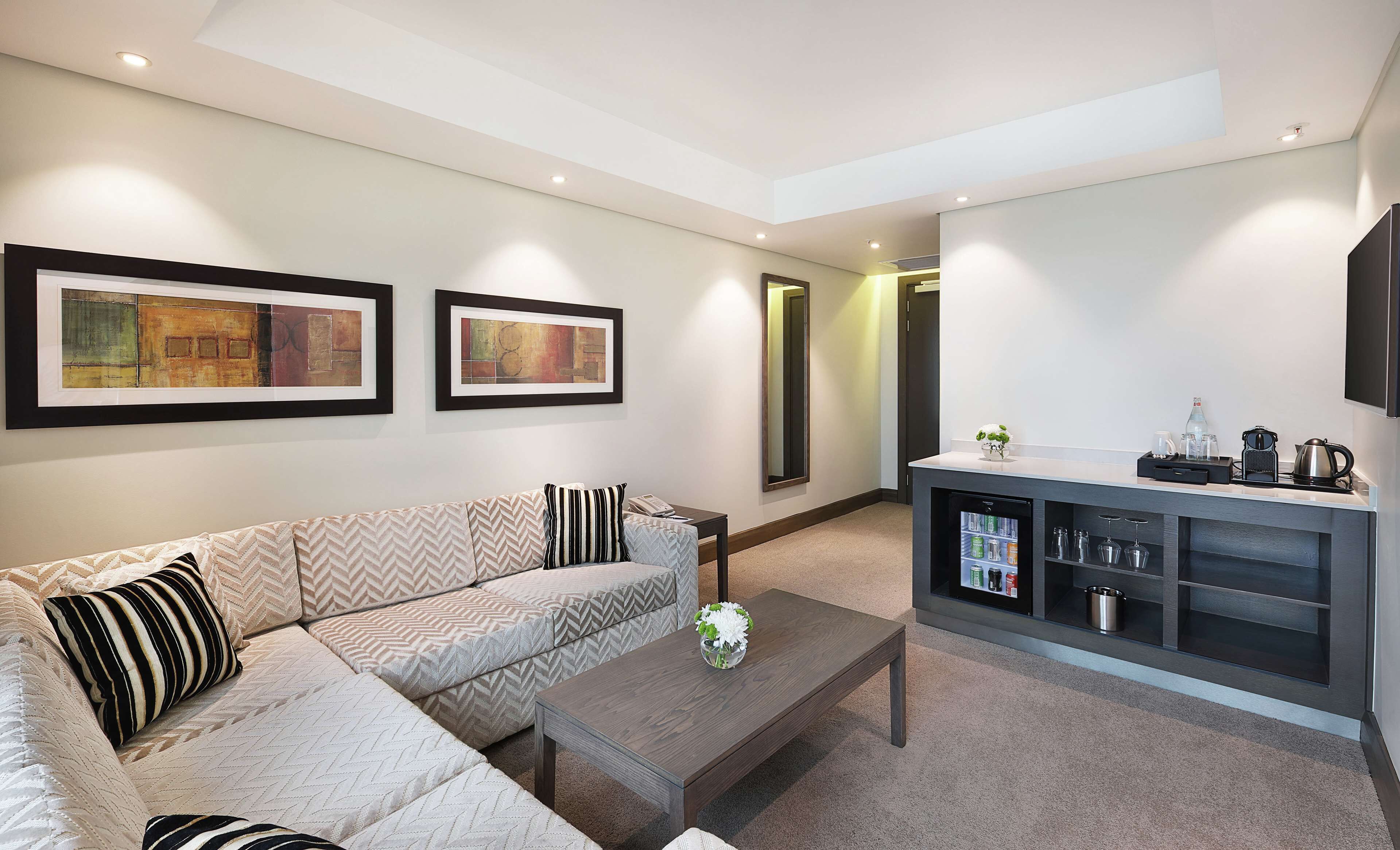 deluxe suite, 1 king bed | living area | 55-inch smart tv with cable channels, tv, ipod dock