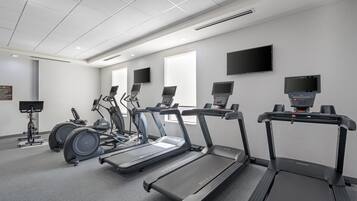 A fitness center with treadmills, elliptical machines, and stationary bikes.