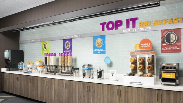 A breakfast station with yogurt, oatmeal, fruit, and protein options. - Tru by Hilton Louisville East (Louisville)