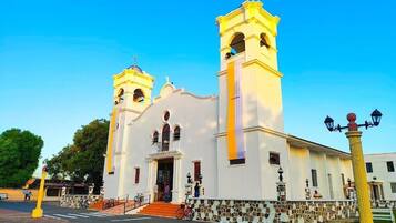 A church with two bell towers, a central entrance, and a tiled facade.
