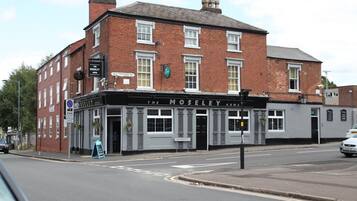 A traditional brick building with a sign reading "The Moseley Arms."