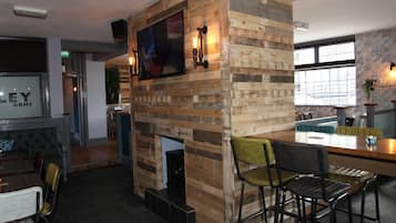 Relax in a contemporary space with a TV, bar area, and seating for casual dining and socializing.