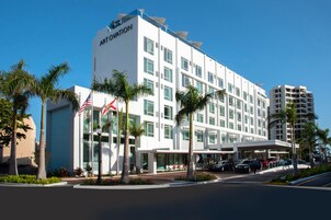 A modern hotel with a white facade, multiple floors, and a prominent "ARTOVATION" sign.