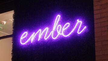 A neon sign spelling "ember" in cursive.