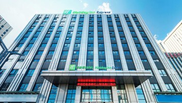 A multi-story building with a prominent Holiday Inn Express sign at the top.
