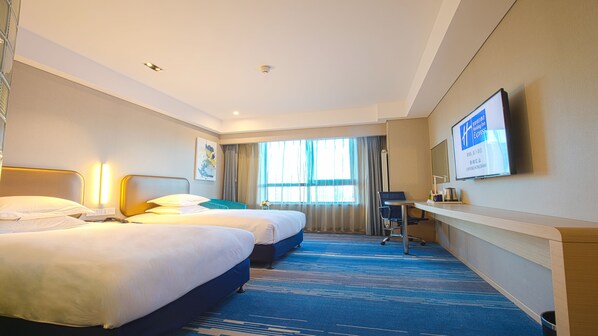 A hotel room with two beds, a desk, a chair, a television, and a large window with curtains. - Holiday Inn Express Chifeng Hongshan by IHG (Chifeng)