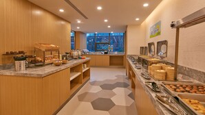 A modern breakfast buffet with various food options, a large window, and a clean, well-lit interior. - Holiday Inn Express Nantong Textile City by IHG (Nantong)