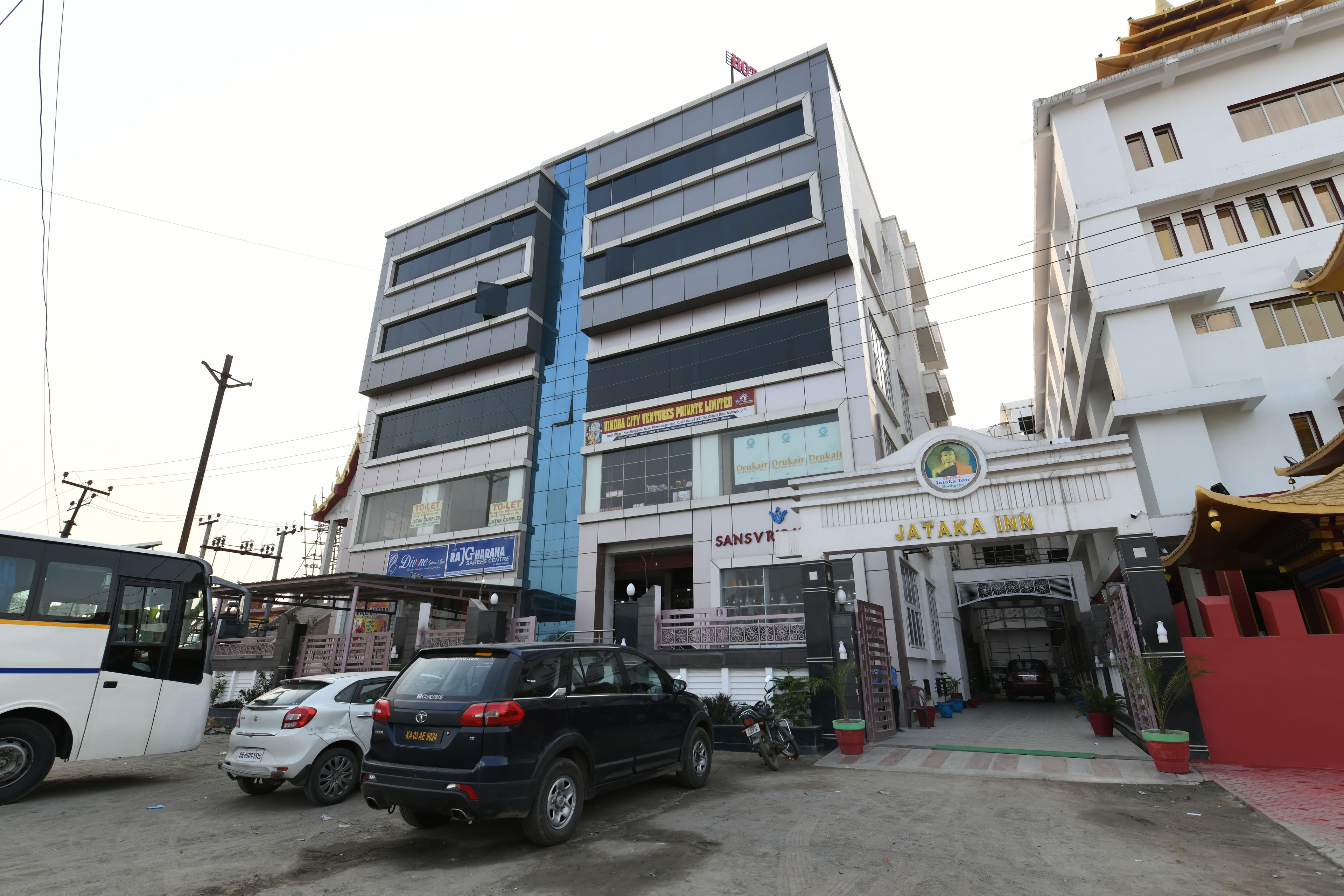 A multi-story building with a visible sign for 'Sans Vir' and 'Jataka Inn'.