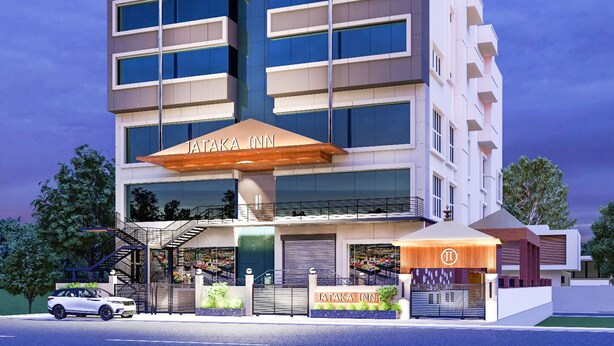Un hotel moderno con una entrada destacada, un espacio exterior cubierto y una escalera visible que conduce a la entrada.