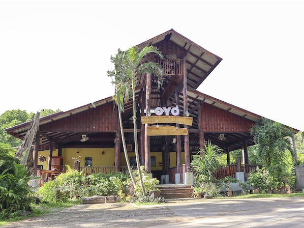 A traditional wooden building with a sign reading "OYO".