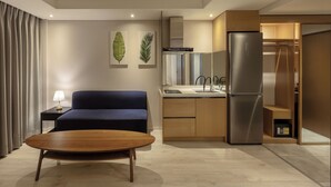 A modern kitchen with a built-in refrigerator, wooden cabinets, and a sink.