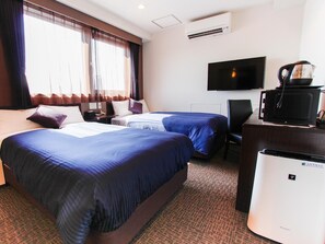 A hotel room with two beds, a flat-screen TV, a coffee maker, and an air conditioning unit. - Hotel Livemax Osaka Dome Mae (Osaka)