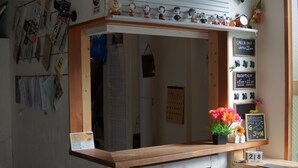 A reception desk with a chalkboard displaying the year 2017, surrounded by various papers and notices. - Guesthouse SUN - Hostel (Osaka)