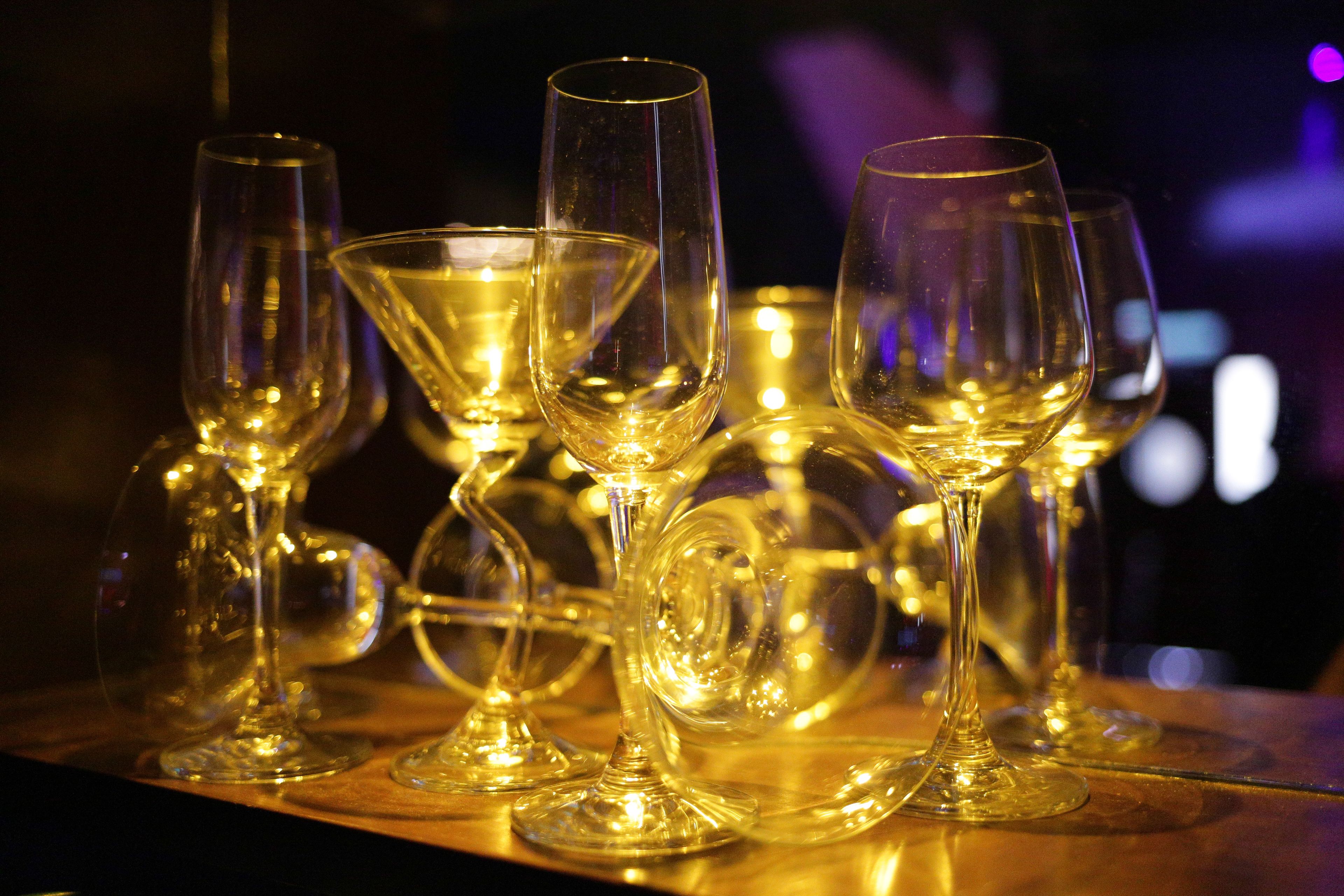 A collection of empty wine glasses on a wooden surface.