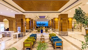 A spacious lobby with a reception desk, seating area, and a large window offering a view of the outdoors. - Kairaba Bodrum Princess & SPA (Bodrum)