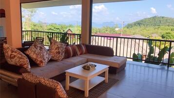 Family Quadruple Room, 2 Bedrooms | Living area | LCD TV