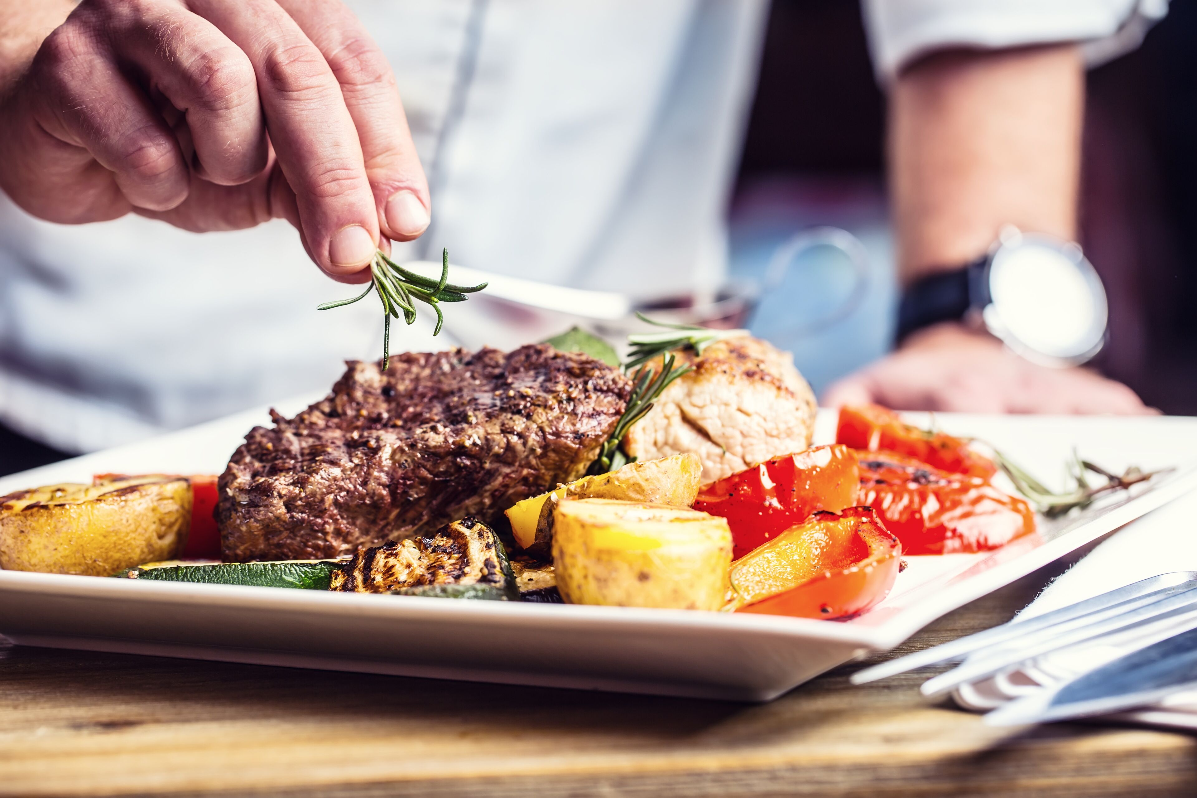 A steak with vegetables on a plate.