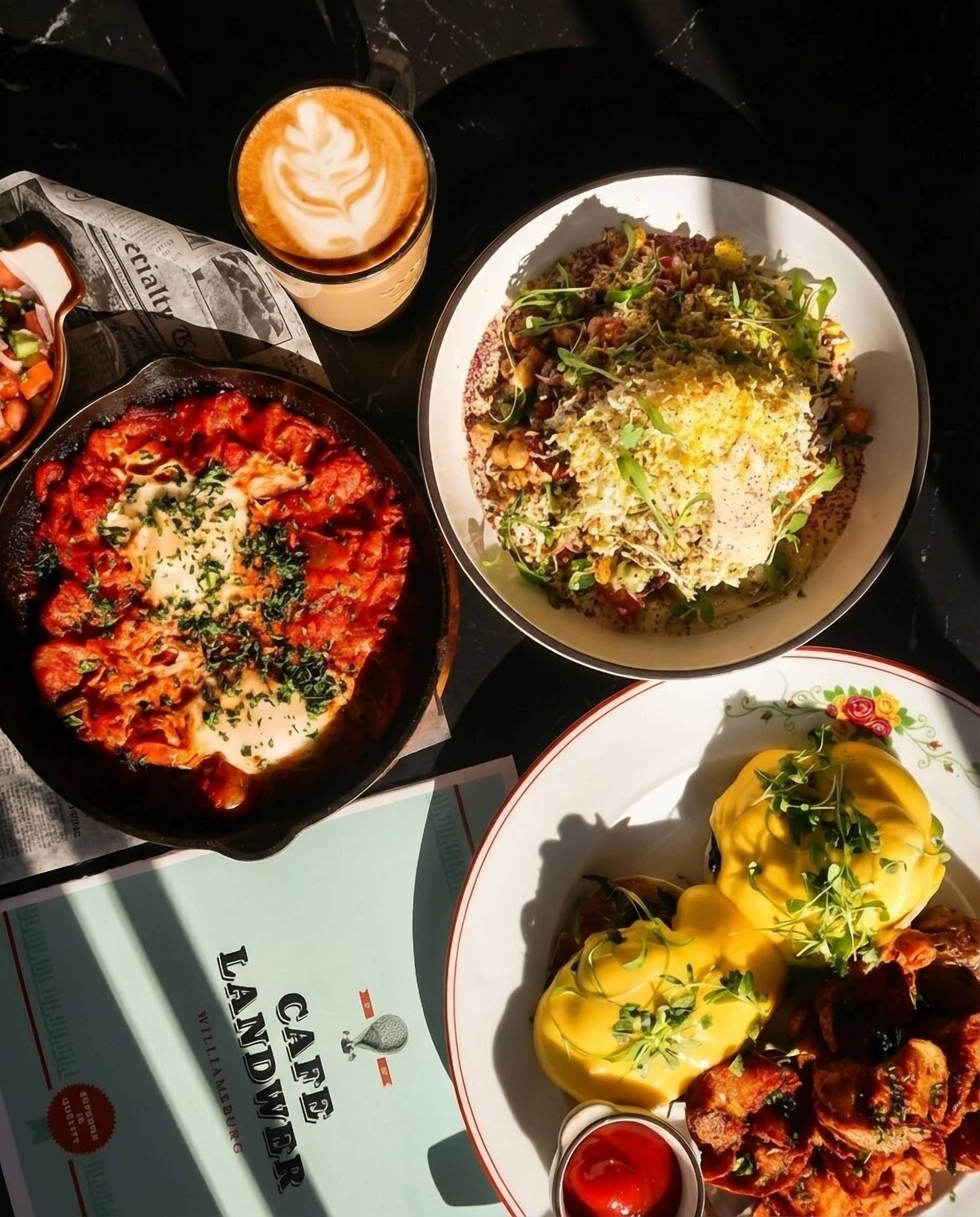 A table with various dishes, a coffee cup, and a menu.