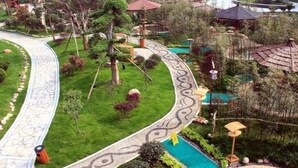A landscaped garden with a winding path, a small pond, and a gazebo. - Dolton Changsha Spa Hotel (Changsha)