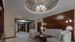 A spacious lobby with a chandelier, a sofa, a coffee table, and a patterned rug. - Dolton Changsha Spa Hotel (Changsha)