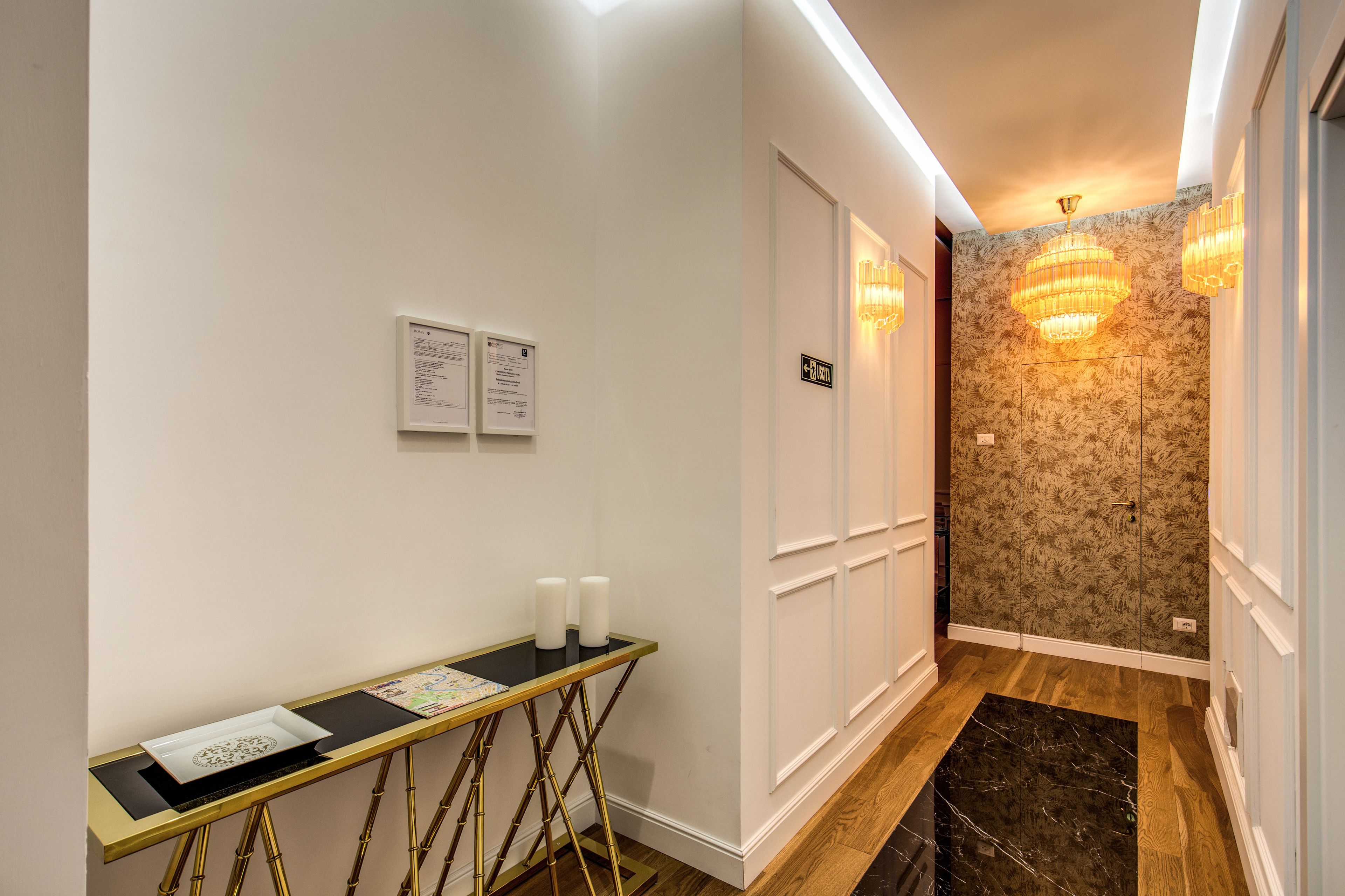 A hallway with a reception desk, a sign indicating room number 1235, and a decorative wall with a chandelier.