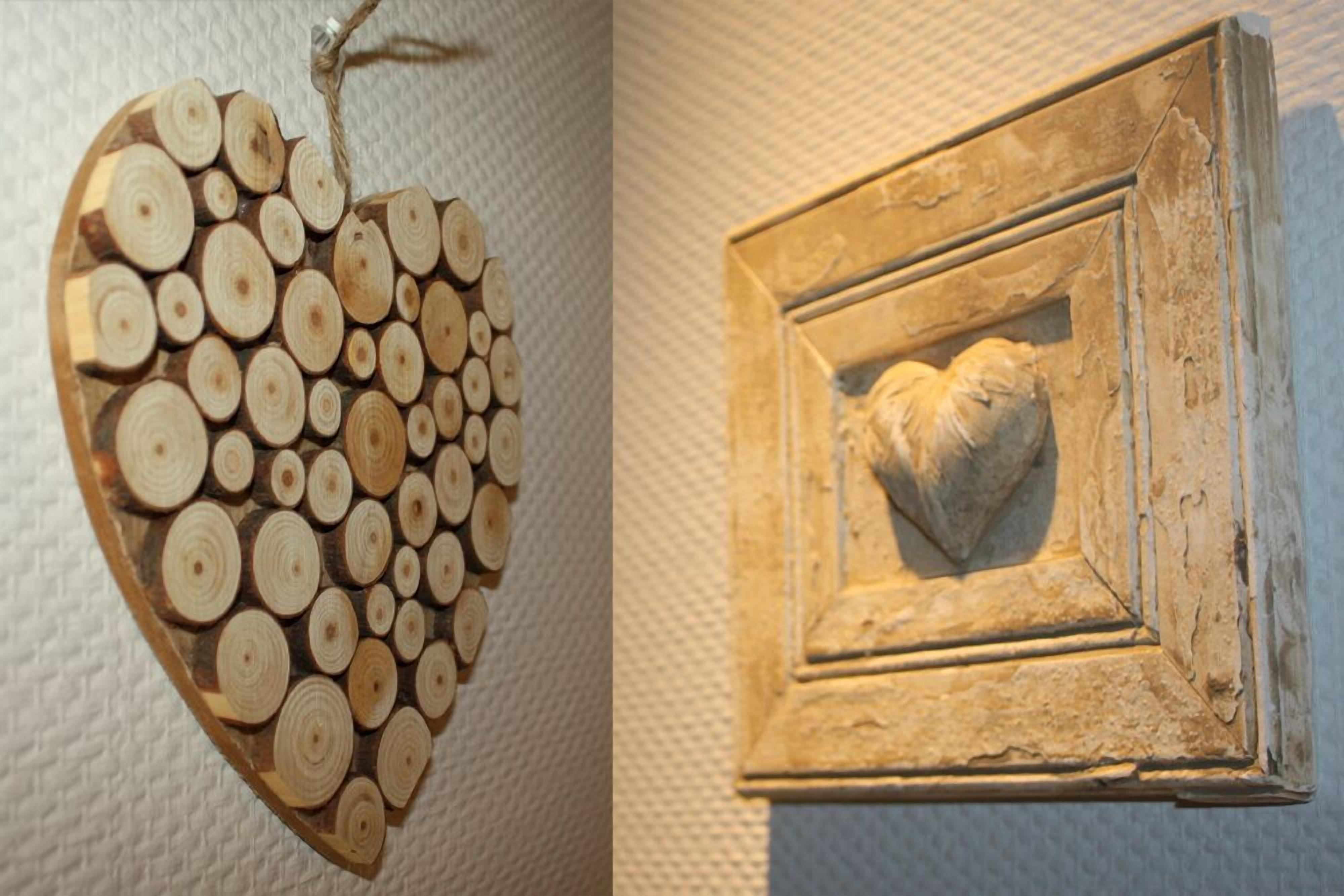 A heart-shaped wooden decoration and a framed picture with a carved heart.